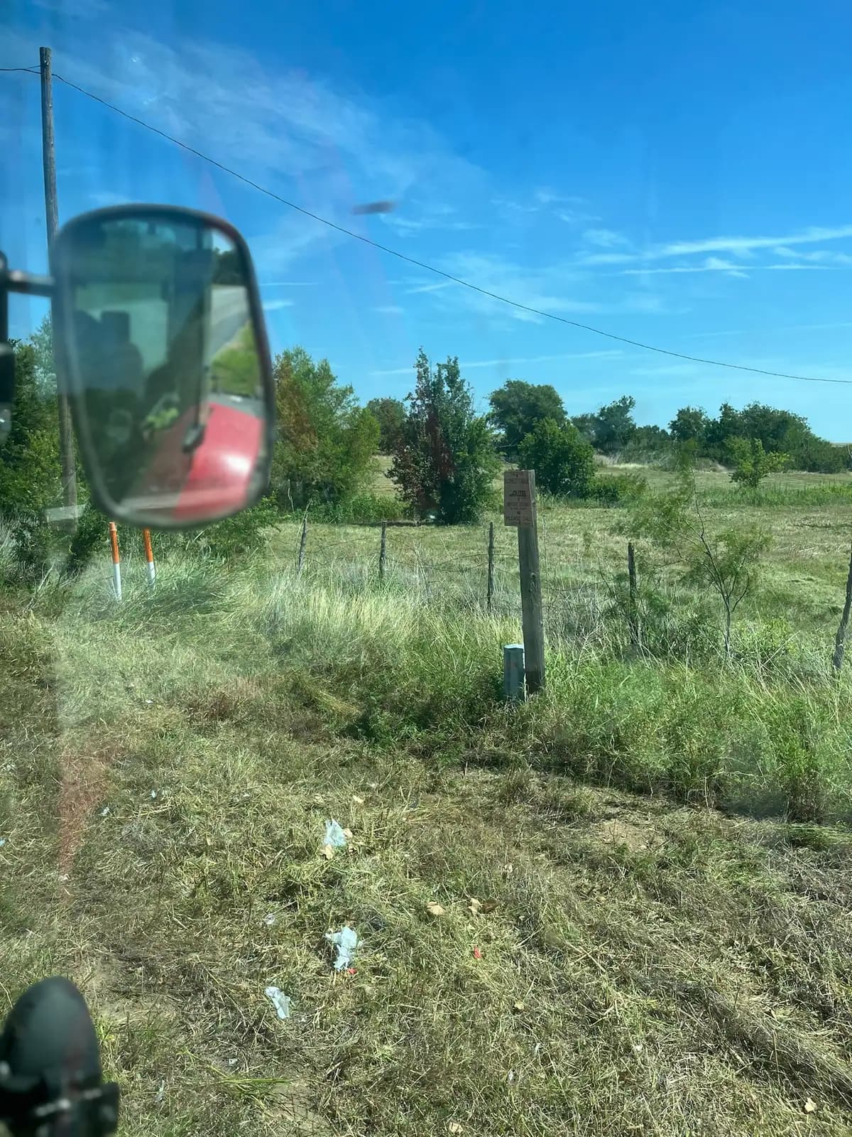 Tall summer grass and weeds before brush hog mowing, seen from the tractor near Granbury, TX